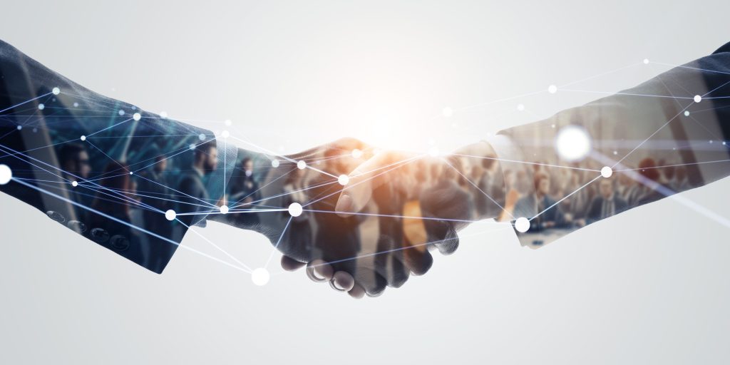 Business handshake symbolising global trade agreements and interconnected markets.