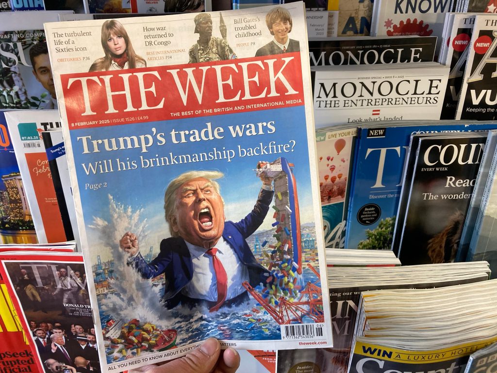 Newsstand cover of The Week magazine featuring Trump’s trade wars and global reactions.