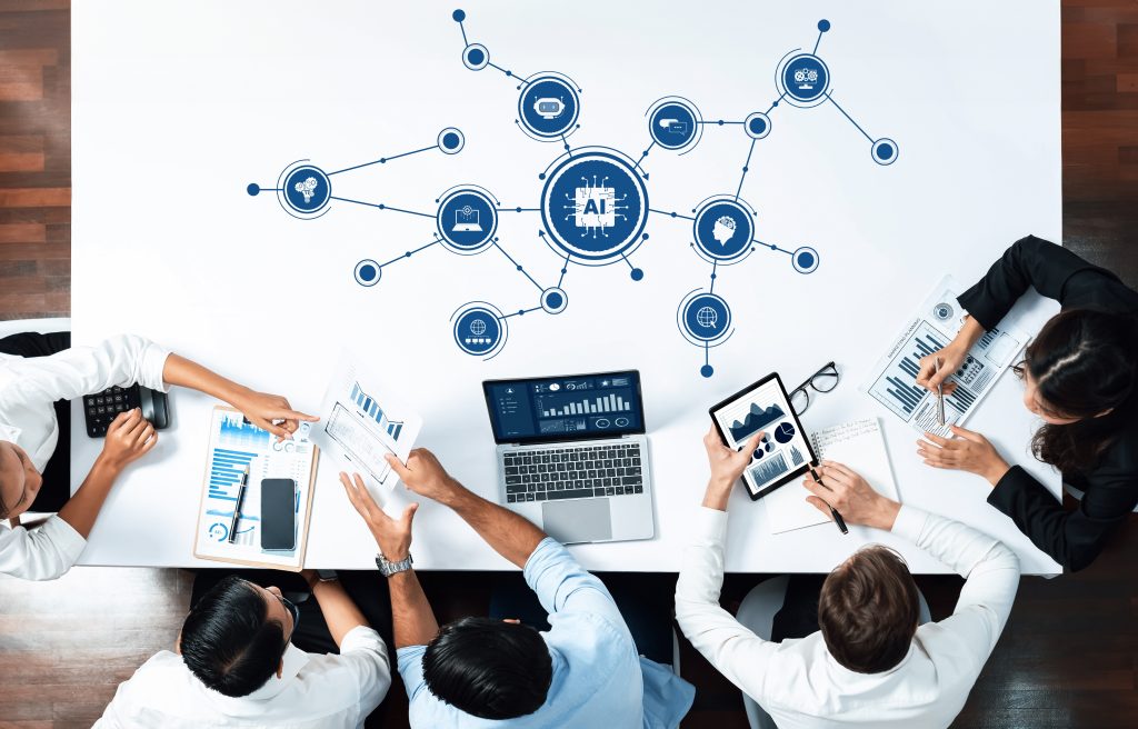 Group of professionals at a table analyzing digital AI network graphics, representing business innovation and AI risk management.