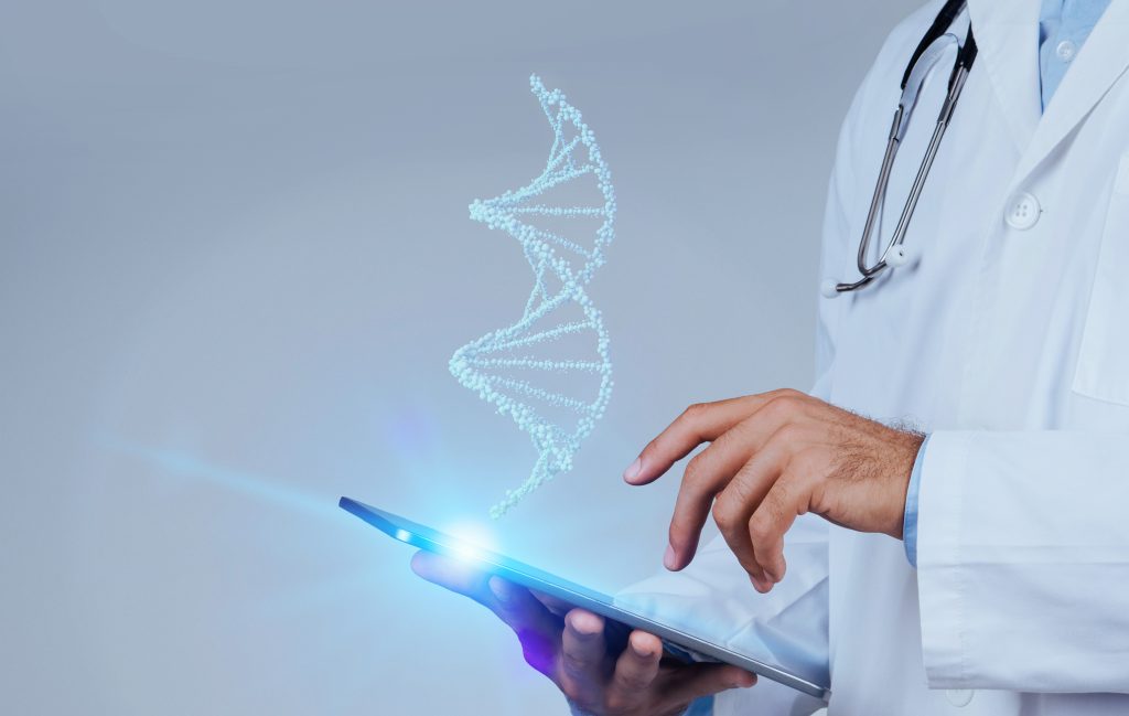 Scientist using a tablet with holographic DNA helix, illustrating the intersection of synthetic biology, digital technology, and medical innovation