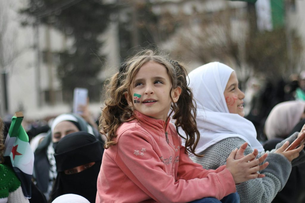A young girl with face paint participates in a demonstration in Idlib, Syria.