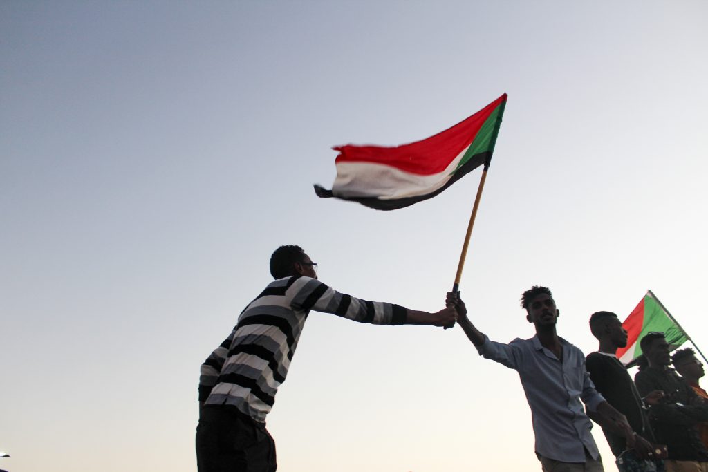 Sudanese protesters holding the Sudan national flag during a demonstration amid the Sudan civil war and political crisis in Khartoum