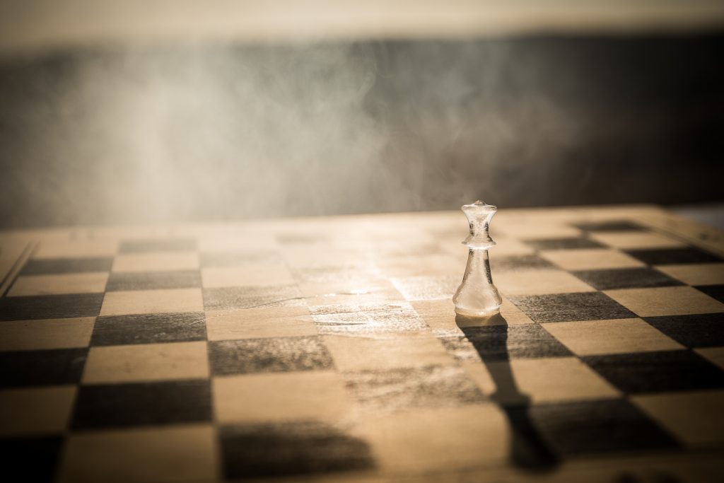 Single chess piece on board representing strategic uncertainty, shifting power dynamics, and changing rules of global security