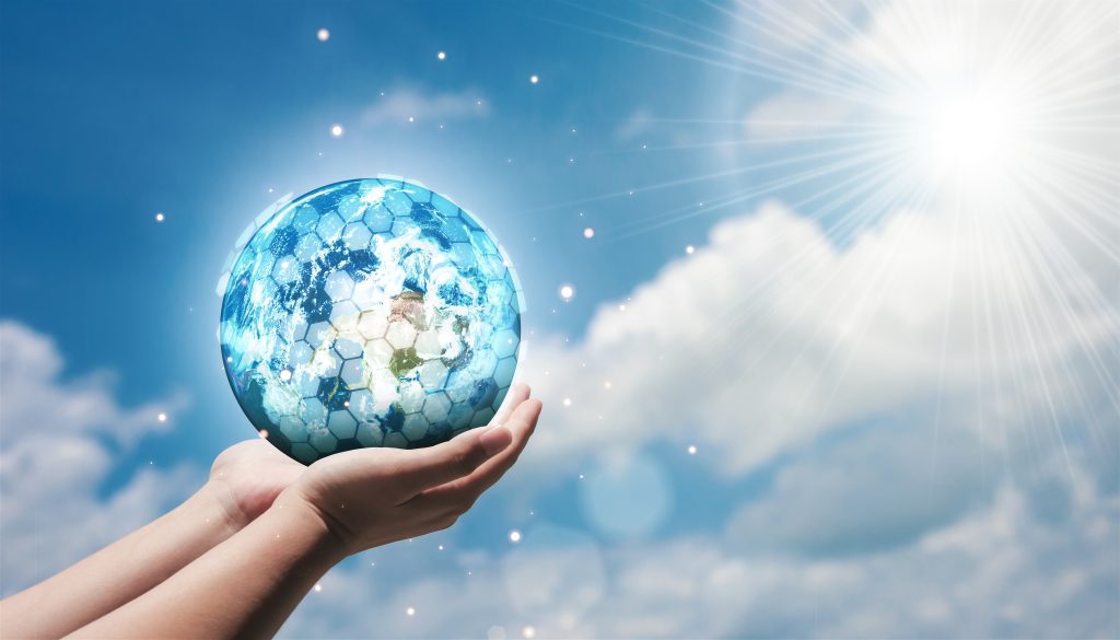 Human hand holding planet Earth symbolising climate responsibility, sustainability, and global security challenges